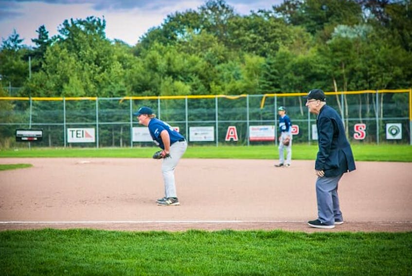 Veteran senior baseball umpire Carl Lake works the first base line at his last baseball game Tuesday night in St. John's.  – Submitted photo by Morgan MacDonald