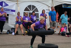 Shelley Lilly of Summerside is encouraged by fellow competitors as she lifts the 100-pound log during the overhead press medley event of the 2019 P.E.I. strong woman competition in Summerside on Saturday. Lilly repeated as the overall winner of the event, which featured eight competitors. Dawn MacInnis Photo