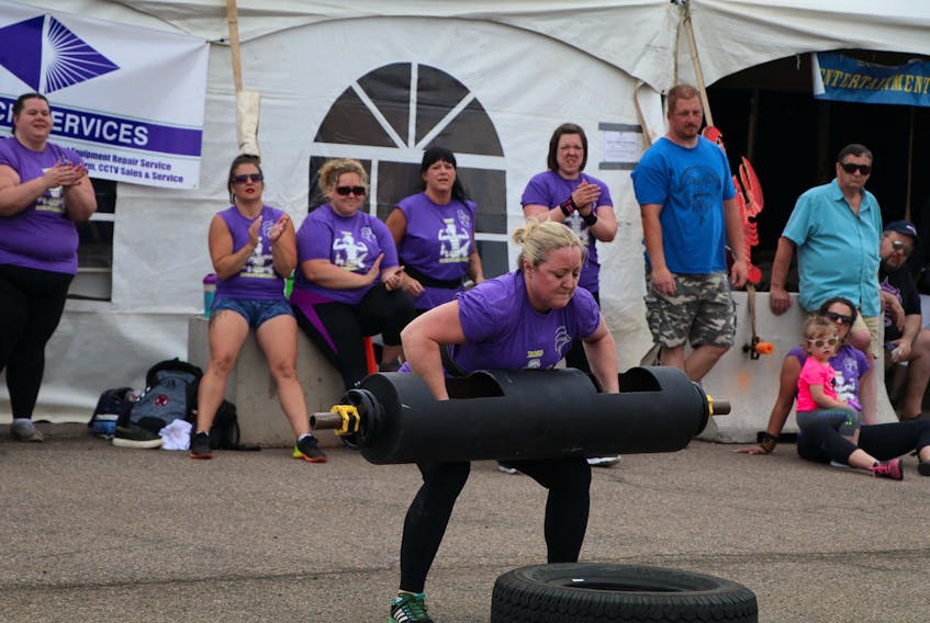 Shelley Lilly of Summerside is encouraged by fellow competitors as she lifts the 100-pound log during the overhead press medley event of the 2019 P.E.I. strong woman competition in Summerside on Saturday. Lilly repeated as the overall winner of the event, which featured eight competitors. Dawn MacInnis Photo