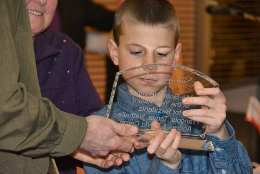 Nine-year-old David Caron holds his family's award Thursday night. The Caron family was honoured with the Good Neighbour of the Year Award for Residents. Colin MacLean/Journal Pioneer