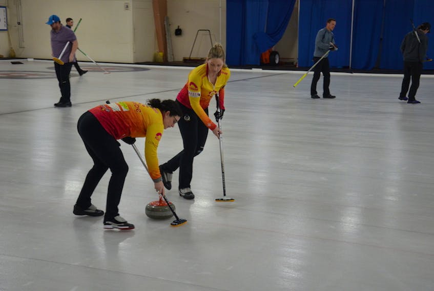 Michelle McQuaid, left, and Meaghan Hughes sweep a stone thrown by skip Suzanne Birt during play in the Island Petroleum Cashspiel at the Silver Fox in Summerside on Saturday afternoon. The Birt rink defeated Mitchell Schut's foursome 5-3. The 16-team event was cancelled shortly after the game due to the announcement of three new COVID-19 cases on P.E.I.