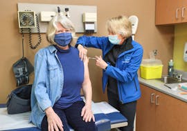 Cathy Faulkner gets a shot of AstraZeneca vaccine from Dr. Linda Ferguson on Saturday, March 20, at the Truro Walk-In Clinic. It was the first COVID-19 vaccination in Nova Scotia to be administered in a primary care setting.  - Communications Nova Scotia