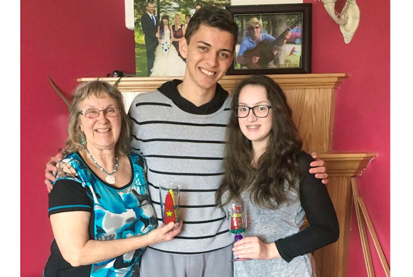 Johnathan Cavalcante with his international exchange host Joan Pearce (left) and her granddaughter, Emily White. Although the two students are the same age and attend the same school, they don’t share any classes.