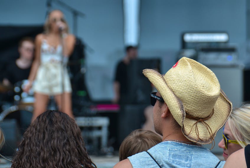 A music fan enjoys a performance on the main stage during the 2019 Cavendish Beach Music Festival.