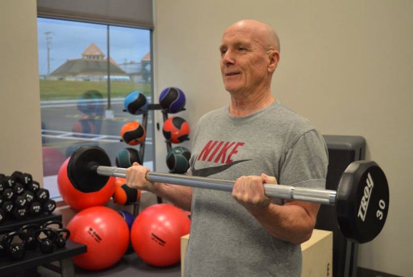 Paul MacDonald of Whitney Pier lifts weights at the new YMCA gym at the Membertou Sport and Wellness Centre on Thursday. The state-of-the-art gym opened its doors on Wednesday.