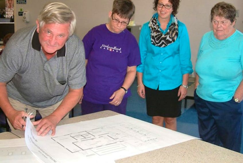 Left to right, Joseph Janega, Patricia Bird, Diana Poirier and Bernice Yhard look over plans for the expansion and renovation of the Regional Occupational Centre in Port Hawkesbury. The facility received $500,000 in funding from the federal government on Thursday.