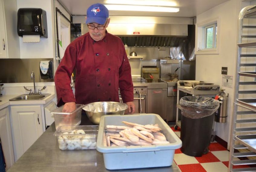 Kevin Hardy prepares a fishermen’s platter at his new seafood takeout eatery, Hardy’s Seafood Delight on Mira Road.