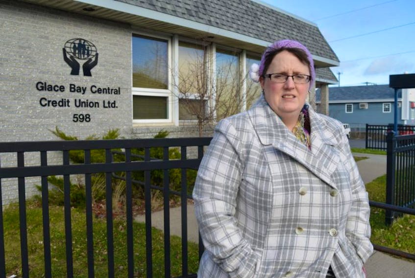 April McKinnon, a single mother of three and a library clerk at the Cape Breton Regional Library branch in Glace Bay, stands in front of the Glace Bay Credit Union. McKinnon wants the man who withdrew the last bit of money from her bank account — after she accidently left her bank card in the ATM — to know they took the money from her children.