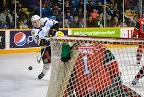 Ross MacDougall of the Cape Breton Screaming Eagles fires a shot on Alexis Gravel of the Halifax Mooseheads during first period Quebec Major Junior Hockey League action at Centre 200 on Friday. Cape Breton won the game 4-1.