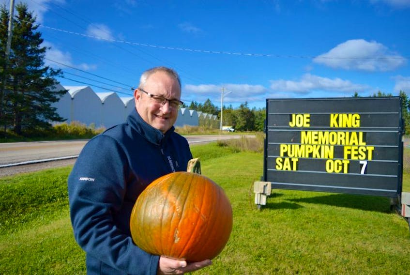 Ron Ivey, president of the Millville Community Centre, holds a pumpkin promoting the annual Joe King Memorial Giant Pumpkin Festival, scheduled for Saturday at the Millville Community Centre in Millville.