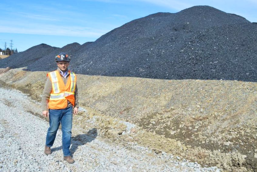 Shannon Campbell, manager at the Donkin Mine, walks by a coal pile in this Cape Breton Post file photo.