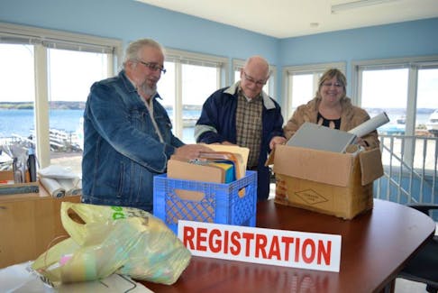 From left, Bill Weatherbee, Wes Stewart and Sharon Robertson, volunteer board members with the Bartown Community Society in North Sydney, were busy this week settling into their new home at the Northern Yacht Club in North Sydney.