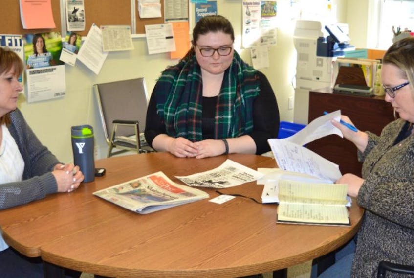 Tammy Marshe, right, with the Nova Scotia Works Employment Services Centre of the YMCA of Cape Breton in New Waterford, talks to staff, from left, Jeanie Burke and Marisa Janes during a recent morning meeting.