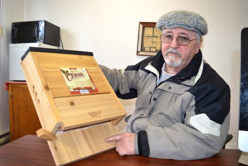 Stan Peach, treasurer of the Port Morien Wildlife Association, holds up a bat house that is capable of holding upwards of 300 bats. Peach said bats are declining across the province and as a result the association has applied for a grant to build and install bat houses around Cape Breton.