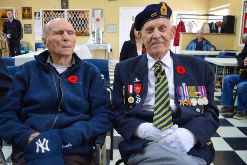 Second World War veterans Marshall Desveaux, left, and Joe Petrie together during D-Day ceremonies at the branch 15 of the Royal Canadian Legion in New Waterford.