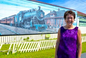 Jesslyn Dalton, project manager for Heritage Day in Sydney Mines, stands in front of a mural at the Sydney Mines Heritage Museum on Thursday. Dalton and her staff are preparing for Heritage Day events, taking place in the Sydney Mines community on Saturday.
