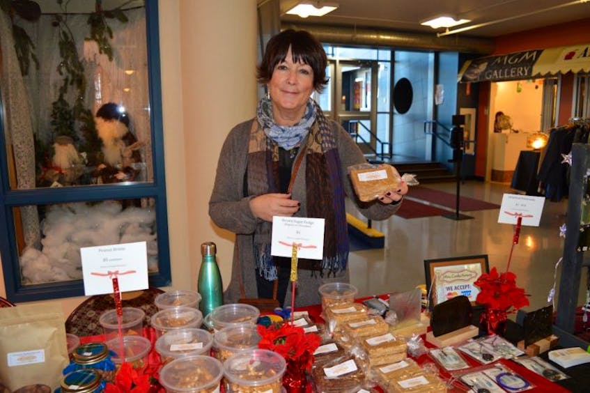 Sue Lanoe shows some of the brown sugar fudge that's her most popular item at the third annual Christmas At The Port, held at the Joan Harriss Cruise Pavilion in Sydney.