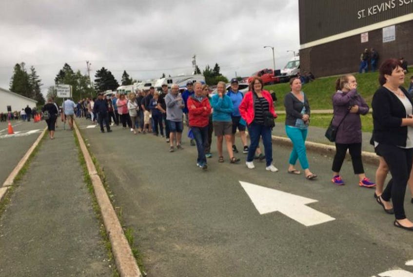People line up outside St. Kevin’s Parish Hall in Goulds to buy their Chase the Ace tickets.
