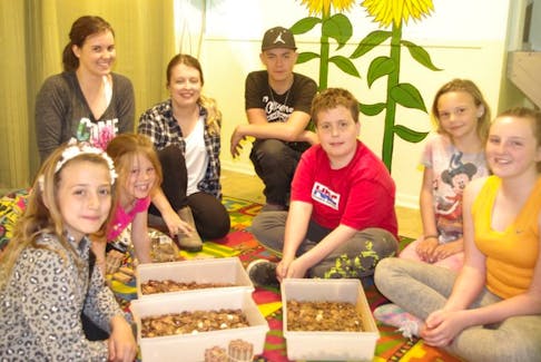 From left, participants Maddy Nichol, Shannon Fuller, volunteer Katrina Eyking, staff Shannon Squarey, volunteer Dylan Parks and participants Angus Donovan, Mya Hogan and Caitlynn Fuller get busy rolling pennies donated to the Clifford Street Youth Centre by St. Joseph’s Catholic Church in North Sydney.