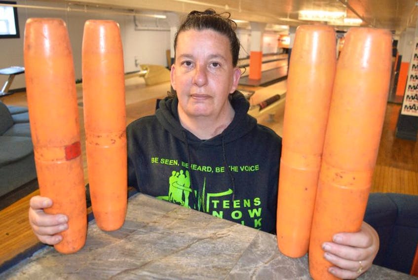 Jeanette MacDonald, secretary of the Glace Bay Y’s Men’s and Women’s Club, shows some of the coloured bowling pins that will be used for the free bowling program for seniors at the Town Bowling Lanes in Glace Bay.