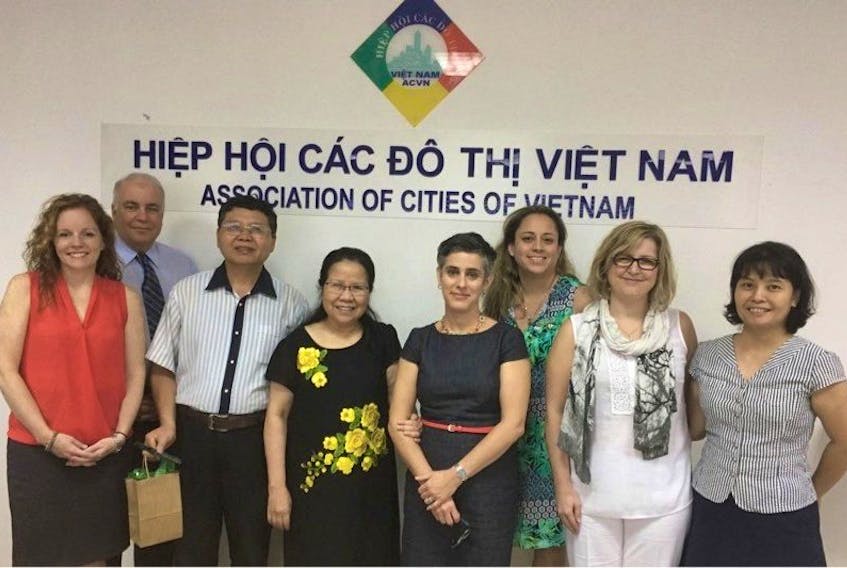 Canadian officials stand with their Vietnamese counterparts in Vietnam after agreeing on a four-year plan to increase economic growth in the country. From left, Carla Arsenault, Bruce Morrison, unnamed researcher with the Association of Cities of Vietnam (ACVN); Nguyen Tho Kim Son, Kristin Marinacci, Perla MacLeod, Brenda Chisholm-Beaton andThi Phuong Thao.