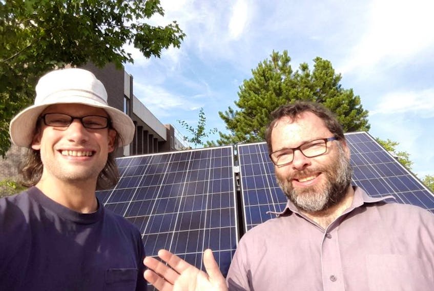 Antigonish Community Energy Co-operative communications co-ordinator Patrick Yancey, left, and co-op president David Morgan snap a solar selfie in front of the co-op’s solar mobile last year. Co-op members will be in Cape Breton to talk about its solar energy home programs later this month.
