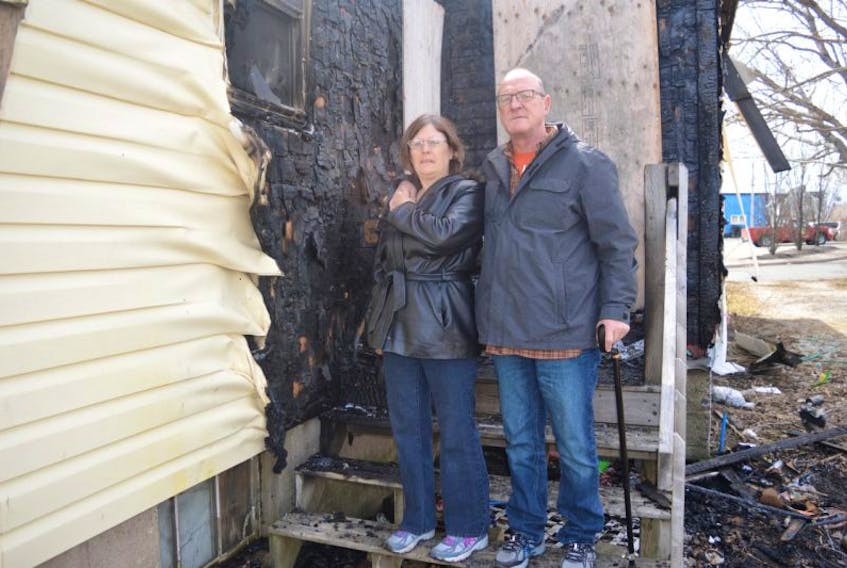Pat Hurley and her partner Glenn MacDonald stand at the back of the house Hurley has rented at 4 Hector St. in Glace Bay for 16 years which was extensively damaged by fire on Sunday. Hurley said they didn’t have any tenant’s insurance, have lost everything and now have nowhere to go.