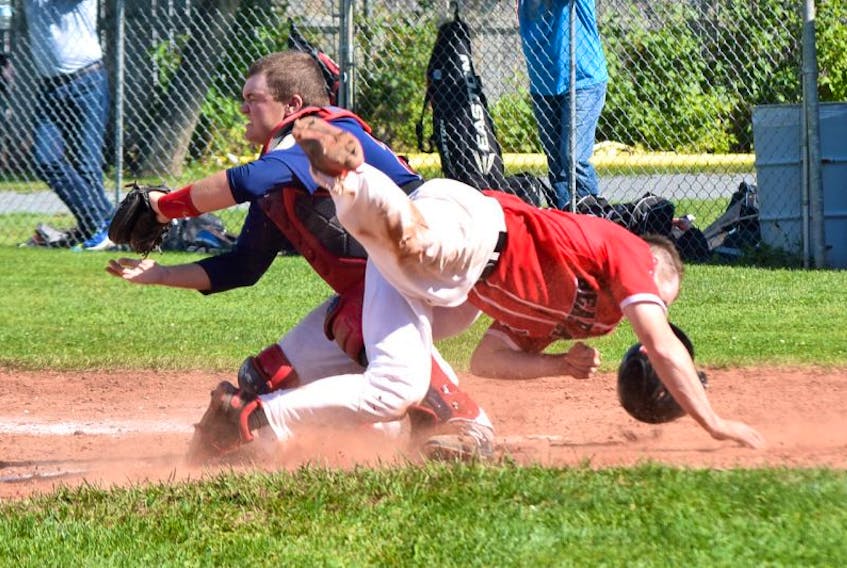 Truro’s John Chapman barrels into Sydney catcher Jordan Sampson, who attempts to block the plate, during action in the Sooners’ 13-2 victory over the Bearcats in Game 2 of the Nova Scotia Senior Baseball League semifinal on Saturday in Truro. Sydney leads the best-of-five series 2-0.