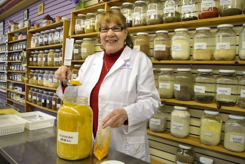 Bernadette MacDonald, owner of Bay Health Foods on Commercial Street, Glace Bay, measures turmenic, which contains a natural antibiotic for inflammation. MacDonald, who offers a large selection of herbs and spices, said she will soon be relocating her business to McKeen Street, which has slowly been evolving from an area of boarded up buildings to a business district.