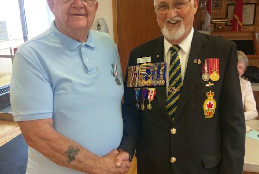 Earl Moore, left, is presented with the Special Service Medal by Tremaine Sampson during a ceremony at the Royal Canadian Legion branch 83 in Sydney Mines. Moore was recognized for his service as a peacekeeper in Vietnam in 1963.