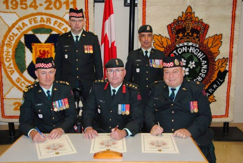 Lt.-Col. Keith Rudderham (seated first left) signs the Change of Command scroll, witnessed by Col. Shawn Hale (commander 36 Canadian Brigade Group), Maj. John Helle (deputy commanding officer, CBH). Standing from left to right are Chief Warrant Officer Jody Merriam (regimental sergeant major of Cape Breton Highlanders) and Chief Warrant Officer Brent Gittens (brigade sergeant major, 36 CBG).