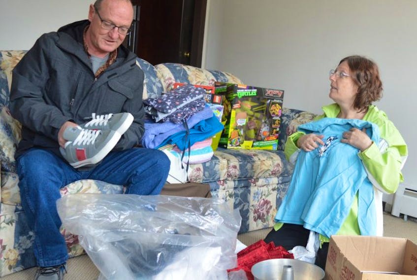 Pat Hurley and her partner Glenn MacDonald go through items donated to them after they lost everything in a fire at a house at 4 Hector St. Glace Bay that Hurley  as rented for 16 years. Hurley said thanks to a landlord hearing about the fire and stepping up to help them, they were able to move into a new apartment at 798 Main St., Glace Bay, Wednesday.