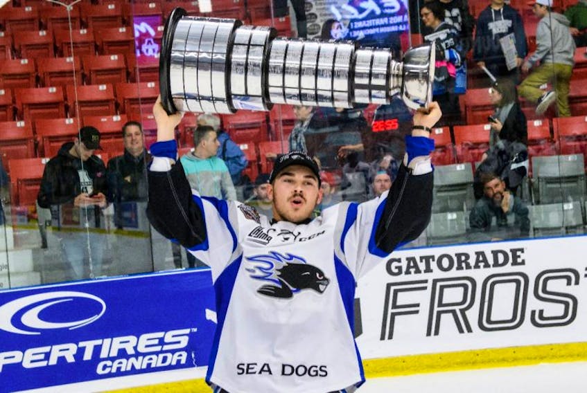 Cole Reginato of Albert Bridge hoists the Quebec Major Junior Hockey League’s President Cup after the Saint John Sea Dogs 5-1 win over the Blainville-Boisbriand Armada at the Centre d’excellence Sports Rousseau in Boisbriand, Que., on Wednesday. The Sea Dogs swept the league final 4-0.