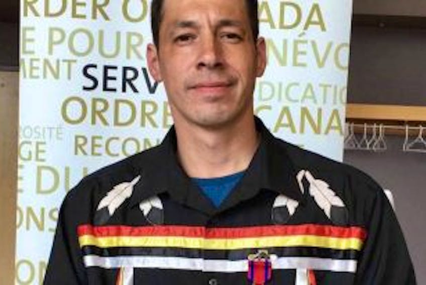 ['Liam Bernard is seen with the Star of Courage medal he received from Gov. Gen. David Johnston during a ceremony in Moncton on Monday. Bernard risked his life pulling a man from a burning vehicle near Melford, N.S., on Sept. 16.']