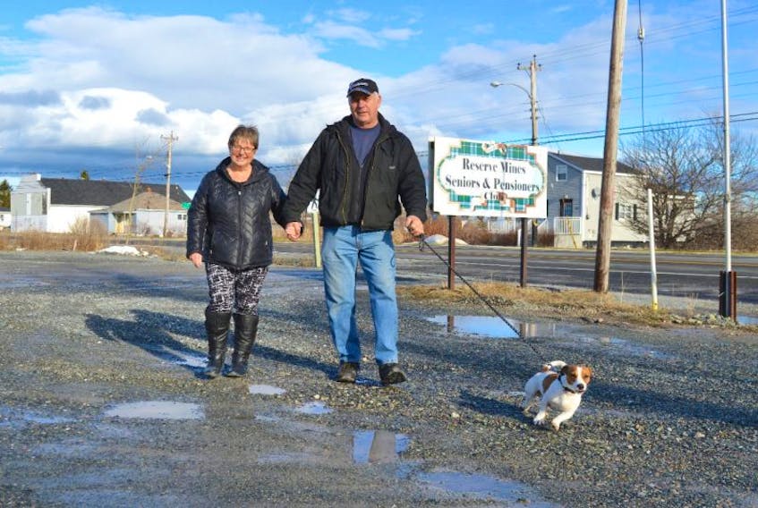 Carol and Walter McKenzie of Glace Bay walk their dog Prince near the Reserve Mines Seniors and Pensioners Club on Friday, where they are both members. Carol McKenzie said the revitalization of Glace Bay should include more businesses so the older members of the community don’t have to go to Sydney to shop.
