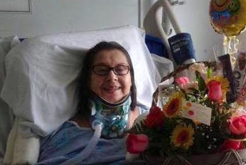 Nancy MacDonald lies in a hospital bed in Ottawa after suffering a spinal cord injury in the remote community of Igloolik, Nunavut, in May. MacDonald was flown to the QEll Health Sciences Centre in Halifax on Tuesday after $20,000 was raised to cover the cost of the trip.