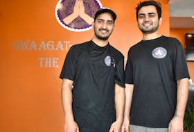 Ajay Balyan, right, and Pankaj Kumar Sharma, one of his chefs, stand in the lobby of Swaagat on Prince Street in Sydney. Balyan, 21, a recent Cape Breton University grad, opened the authentic Indian restaurant two weeks to give Cape Breton’s growing population of students from Indian a taste of home.