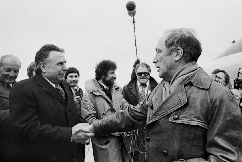 Federal cabinet minister and Cape Breton Highlands-Canso Liberal MP Allan J. MacEachen, left, greets then-prime minister Pierre Trudeau at the Sydney airport in April 1974. MacEachen, who became the country's first deputy prime minister in 1977, died Tuesday at the age of 96.