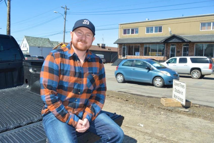 Michael MacInnis of Frenchvale sits on the tailgate of his truck beside a pothole on Prince Street in Sydney. MacInnis’ girlfriend recently took a video of him driving through a rough section of Prince Street hitting bumps and potholes. The video has gone viral.
