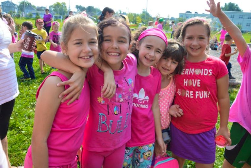 From left, Elin Laderoute, Davis Sullivan, Alivia Dolhanty, Emma Vatcher and Hannah Rudderham, all 8, share hugs and laughs during the Étoile de l'Acadie family barbecue for Anti-Bullying Day.