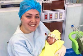 Mary MacKinnon of Westmount is shown holding an infant in Quito, Ecuador. MacKinnon was one of 24 students and four staff members to travel to the country as part of the Cape Breton University International Nursing Experience.