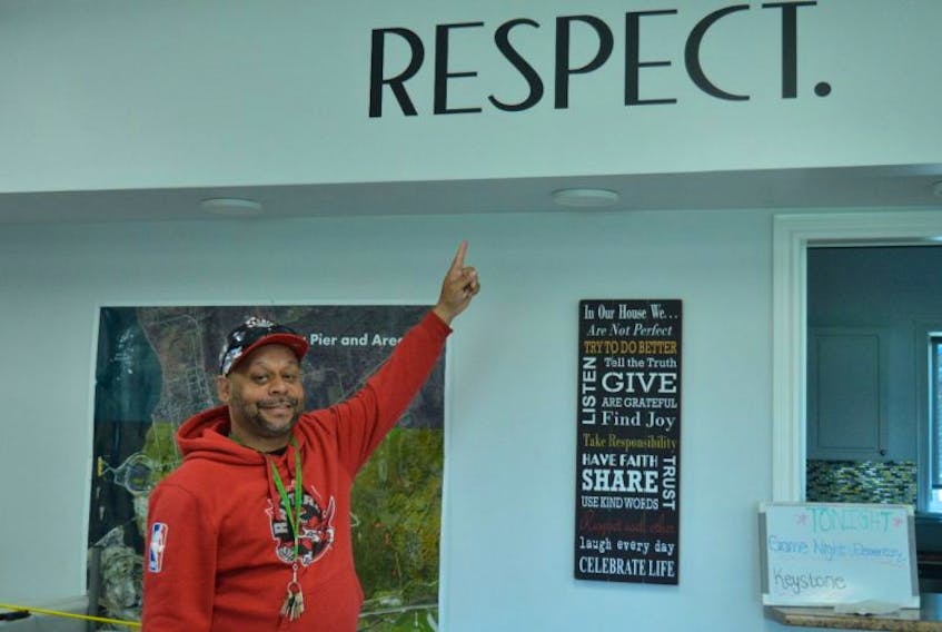 Chester Borden of the Whitney Pier Boys and Girls Club shows a sign that emphasizes the number one rule at the club — respect each other.