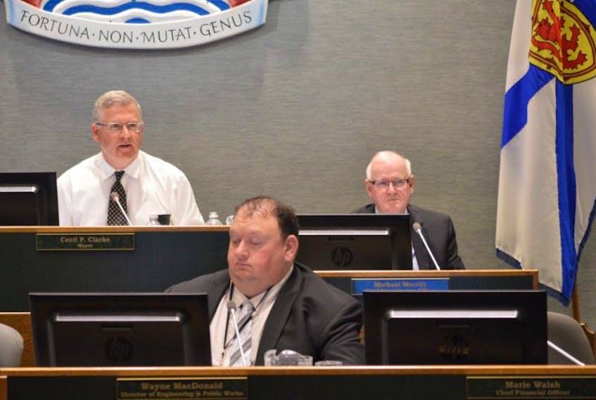 CBRM Mayor Cecil Clarke, top left, speaks during budget discussions Thursday, while CAO Michael Merritt, right, and Wayne MacDonald, director of public works and engineering, listen.