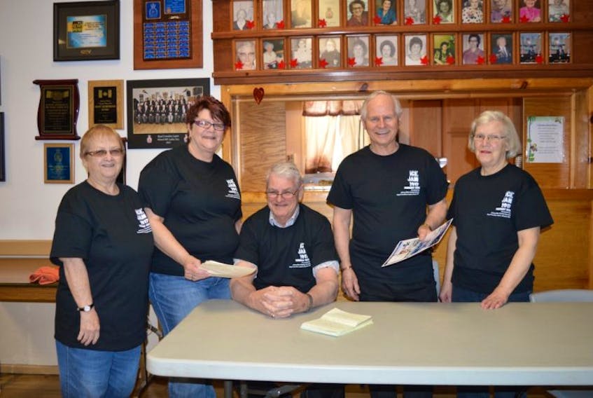 From left, volunteer Merdina Bond, Sydney Mines Legion bar manager Wendy Fraser and volunteers Marty Pickup, seated, Eugene Ramsey and Jean Ramsey go over the menu for Sunday’s Johnny Miles Festival Society Ice Jam.