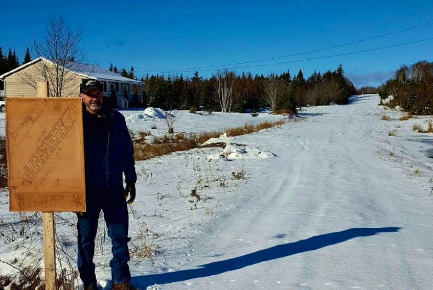 Groves Point resident Clifford MacNeil stands beside a sign showing the lots of a subdivision he wants to continue developing on family-owned property. MacNeil is upset that the Cape Breton Regional Municipality recently refused to approve the final plan of the project, which was first given the OK before amalgamation in 1994.