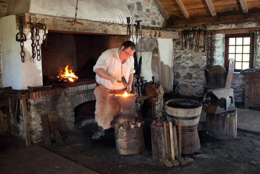 Graham Tourneur works in the forge at the Fortress of Louisbourg National Historic Site in this Parks Canada photo. Visitation at the fortress was up by 39 per cent year-to-date as of the end of July over the same period last year. Admission at national parks sites is free this year with the Discovery Pass program.