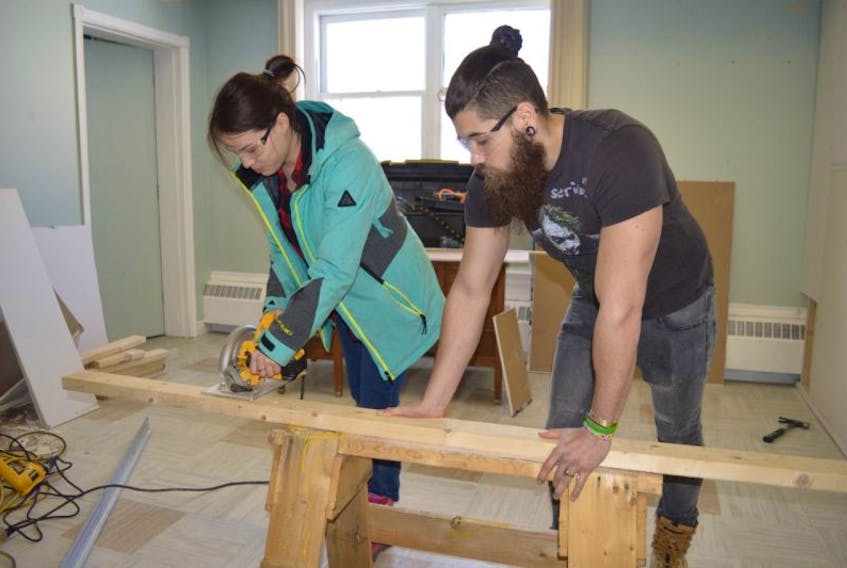 Nova Scotia Community College Marconi Campus first-year carpentry students Kristina Johnson, left, and Dominic MacKinnon construct a wall for Community Cares Youth Outreach, one of many community services projects undertaken by the carpentry program students.