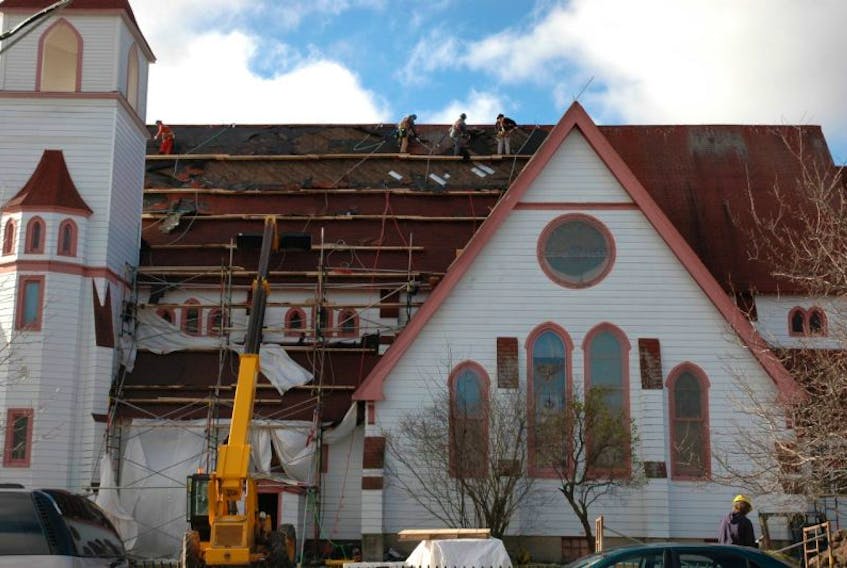 In this Cape Breton Post file photo, Andy Jessome, left, and Bernie MacNeil with Joneljim Construction work on the replacement of shingles on the roof of St. Matthew Wesley United Church in North Sydney due to a winter storm.