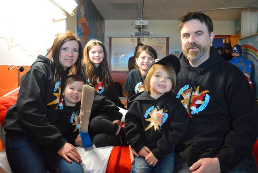 The family of Caleb MacArthur sits on a bed in a newly renovated room, known as Caleb’s Courage Superhero Suite, in the pediatrics unit at the Cape Breton Regional Hospital in Sydney. The family has been fundraising since 2015 to make the room a reality in memory of Caleb. From left, Nicole Forgeron, Emery MacArthur, Ella MacArthur, Aubreigh MacArthur, Lauchlin MacArthur and Mike MacArthur.