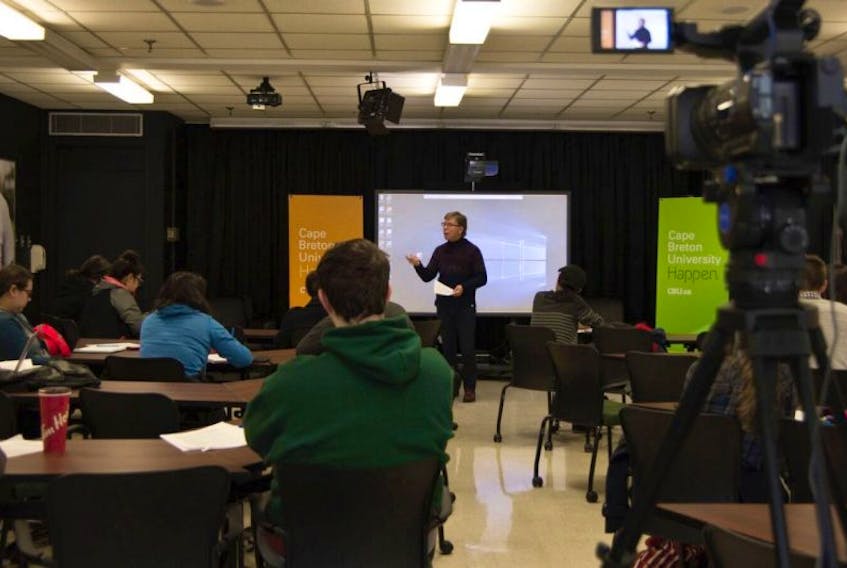 Prof. Rod Nicolls is seen here teaching a group of students in class and online at Cape Breton University. The Meaning of Life was one of the first free open online courses offered by the university.